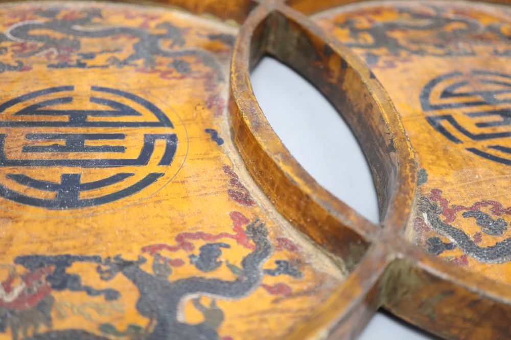 A 19th/20th century Chinese double circular wood and lacquer tray, length 42cm